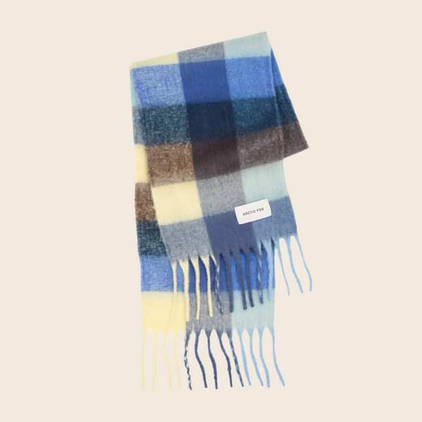 Blue and yellow plaid scarf with fringes on a beige background