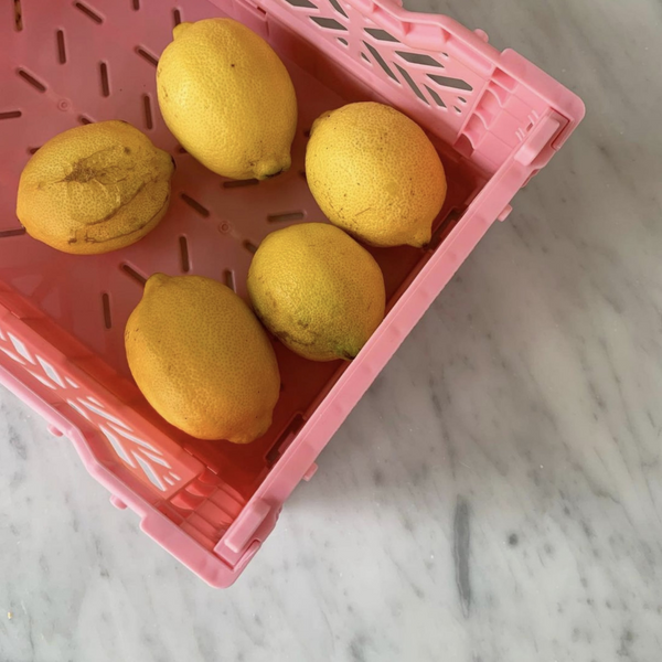 Aykasa storage crates in pink, holding lemons