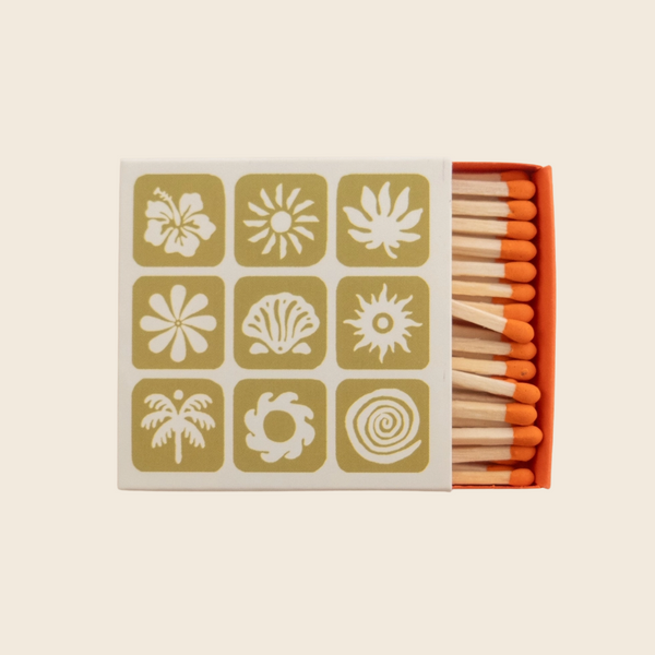 Matchbox with decorative labels on a beige background