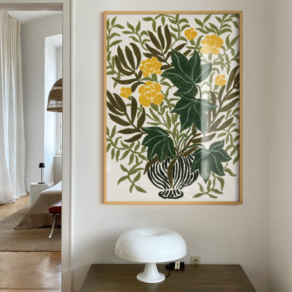 Framed floral artwork on a wall with a modern interior setting.