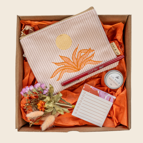 Gift set with pouch, pen, lip balm, and notepad in a box