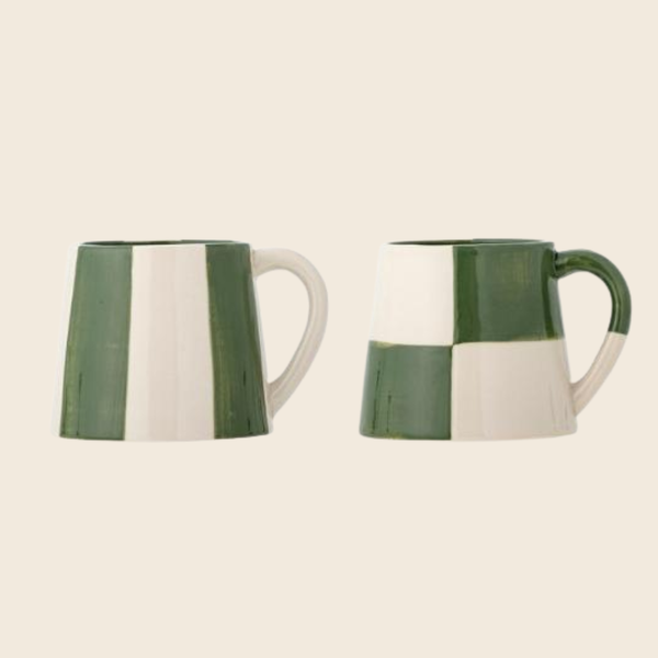 Two green and white checkered and striped ceramic mugs shown from the side against a solid light beige background.