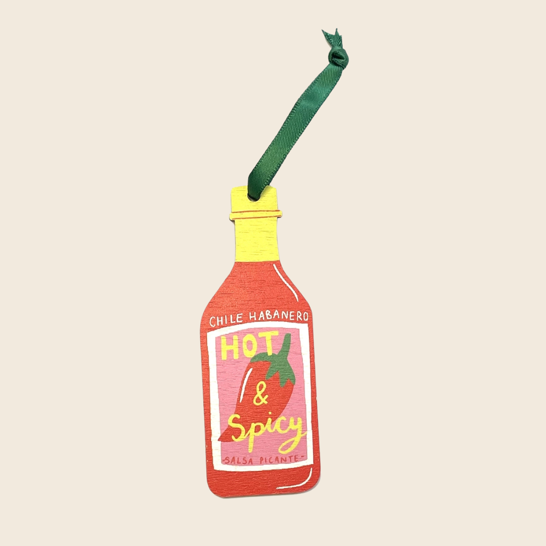 Hot sauce bottle-shaped ornament with 'Hot & Spicy' text on a beige background