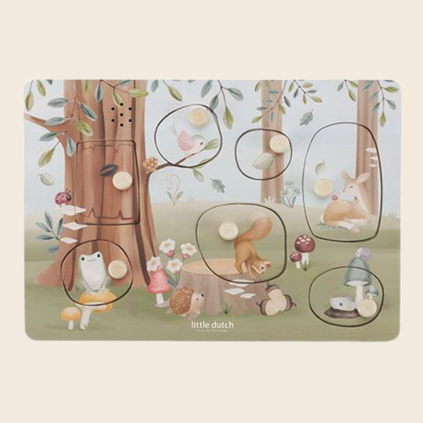 A children's wooden jigsaw puzzle featuring a whimsical woodland scene with trees, mushrooms, a bird, a rabbit, a squirrel, and small animals. The puzzle has several circular cutouts showing missing pieces, and the brand name 'little dutch" is printed near the bottom centre.