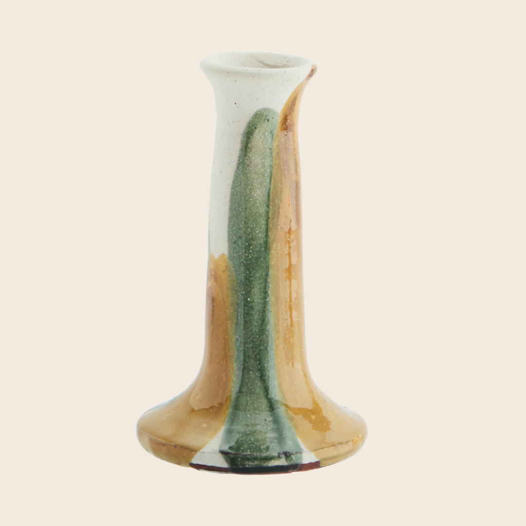 Cylindrical ceramic candle holder with gradient colours on a beige background