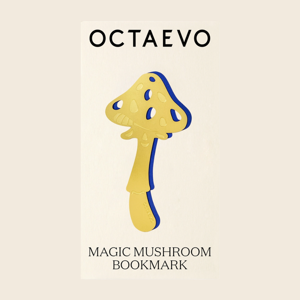 A mushroom-shaped gold bookmark  on a cream background with the text 'OCTAEVO' at the top and 'MAGIC MUSHROOM BOOKMARK' at the bottom.
