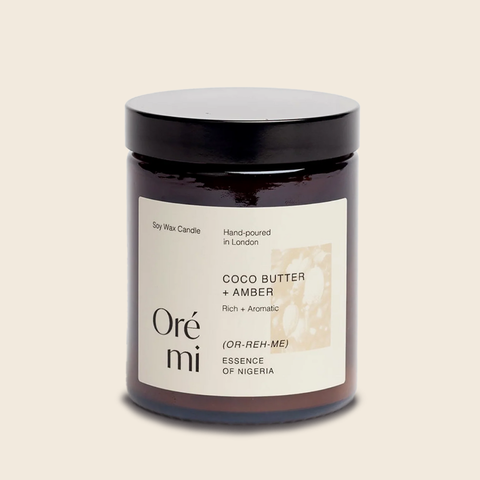 Candle jar labeled 'Oré mi' with a beige background