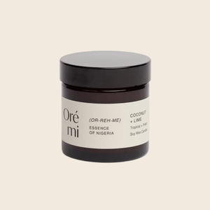 Jar of Ore Mi coconut lime candle on a beige background