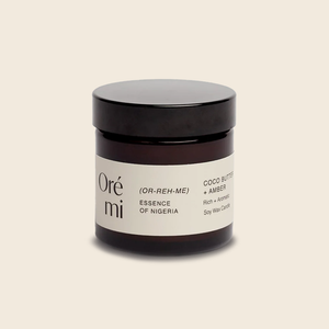 Ore Mi Coco Butter and Amber mini candle on a beige background