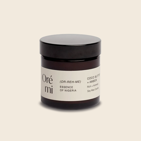 Ore Mi Coco Butter and Amber mini candle on a beige background