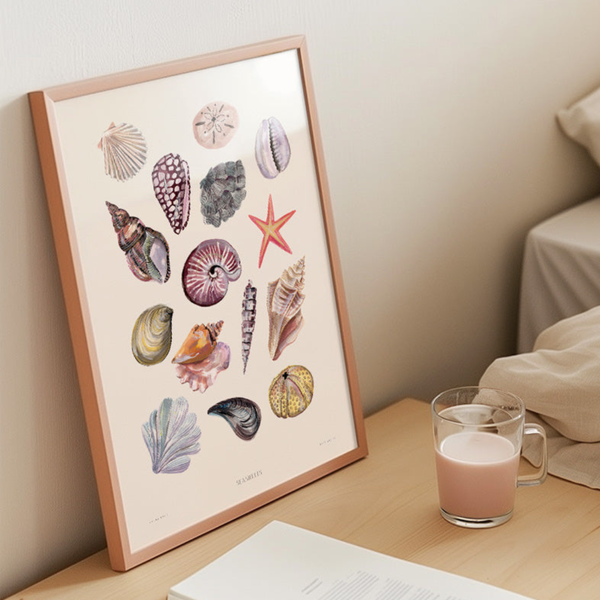 Framed artwork of seashells and a starfish on a table with a glass of milk.