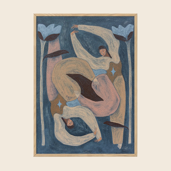 A framed abstract art print featuring two stylised figures in flowing cream and pink garments against a deep blue background, enclosed in a light wood frame on a warm off-white backdrop.