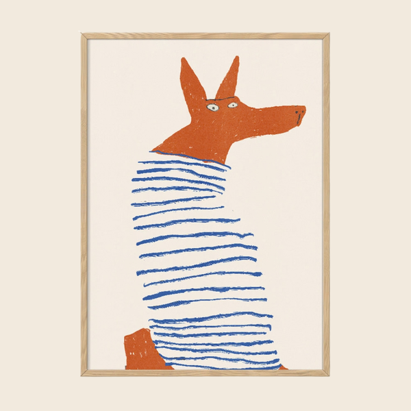 A framed art print featuring a stylized orange dog wearing a blue and white striped sweater, set against a cream background with a light wood frame.