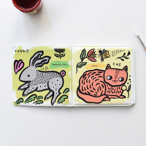 Open book with illustrations of a rabbit and a cat on yellow pages.