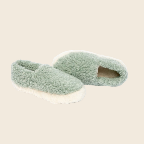 A pair of light green and cream full wool slippers designed for adults.